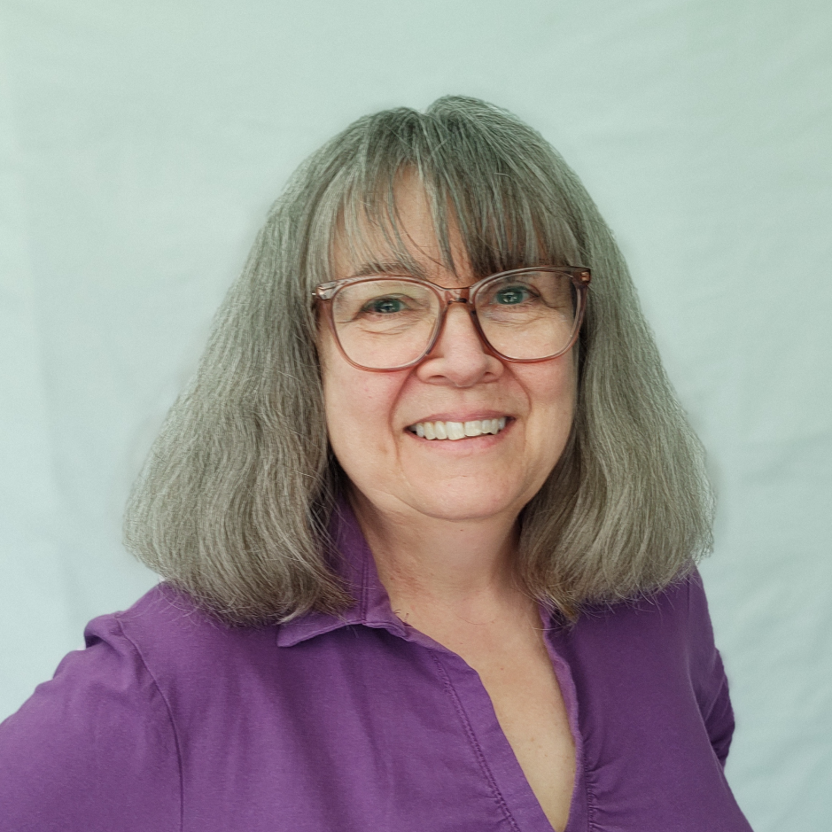 Image of Joni Page wearing glasses and a purple shirt